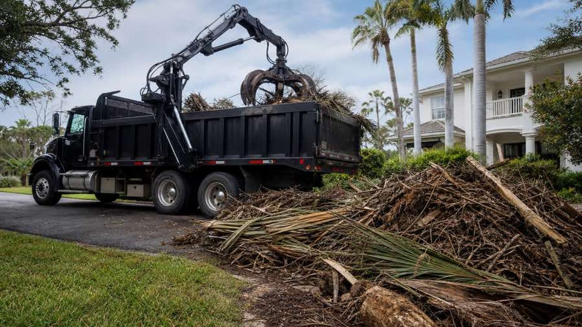 AI-generated image of property owner photographing a tape measure across an Ormond Beach driveway entrance with trees, a gate, and the debris area visible in the background