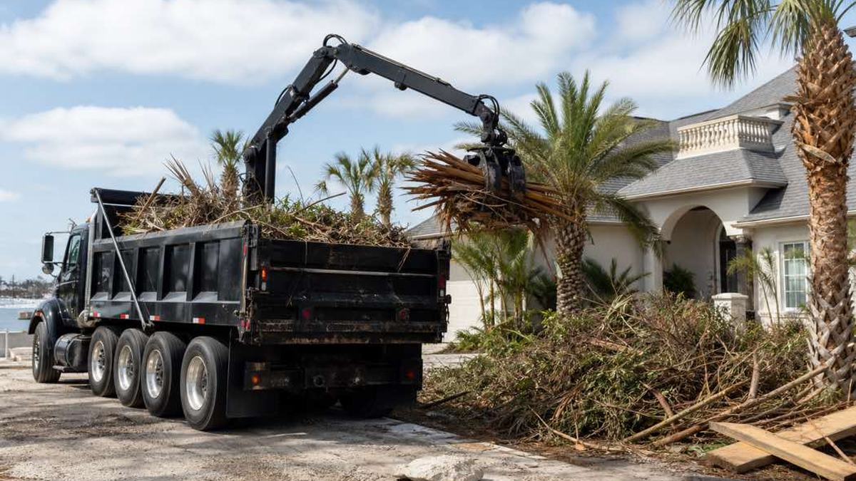 AI-generated image of grapple truck beside a separated pile of cut branches and logs at a Daytona Beach property after storm cleanup