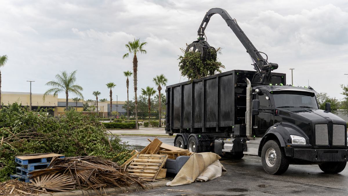 AI-generated image of commercial debris hauling with a grapple truck loading approved construction and landscape debris